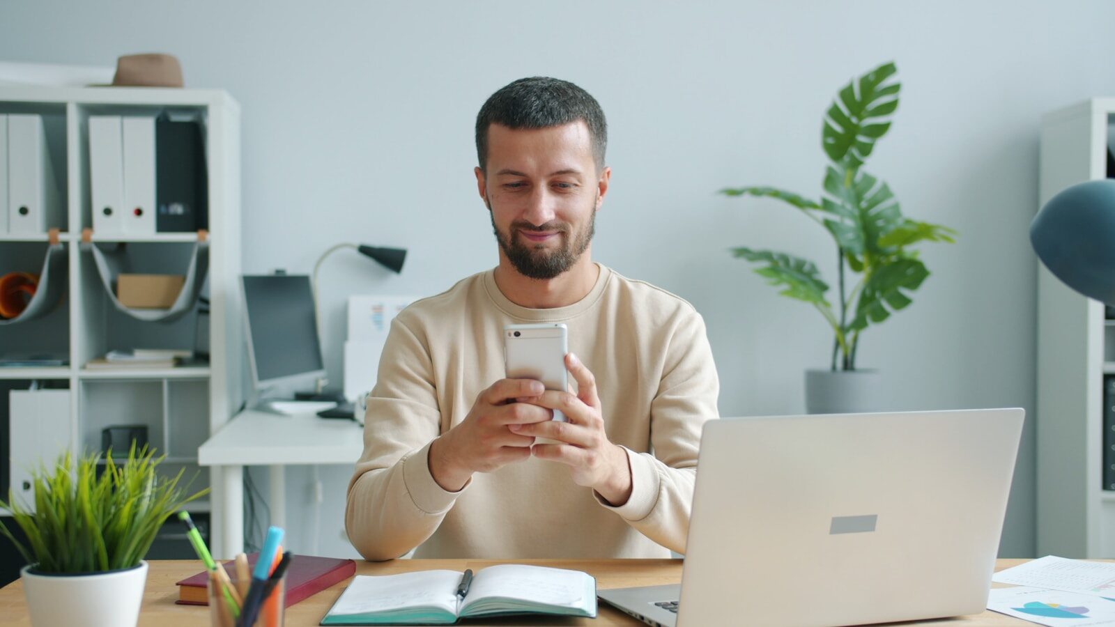 A developer smiling at a laptop